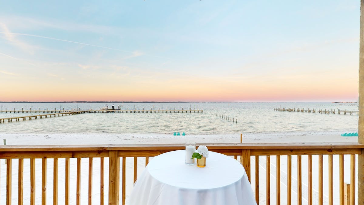 a table next to railing overlooking the beach