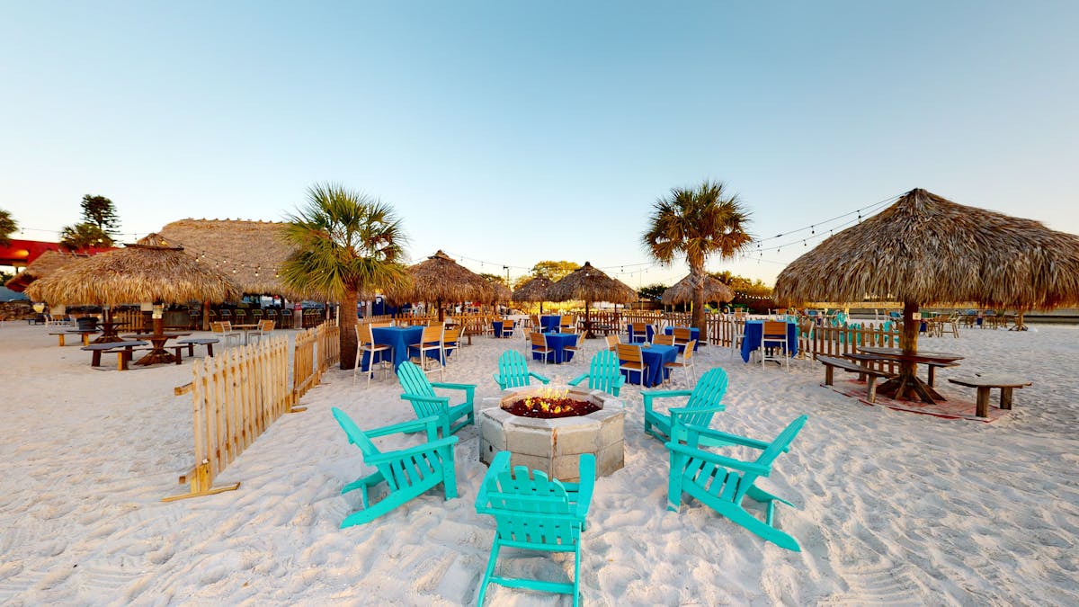 chairs and a fire pit on the beach