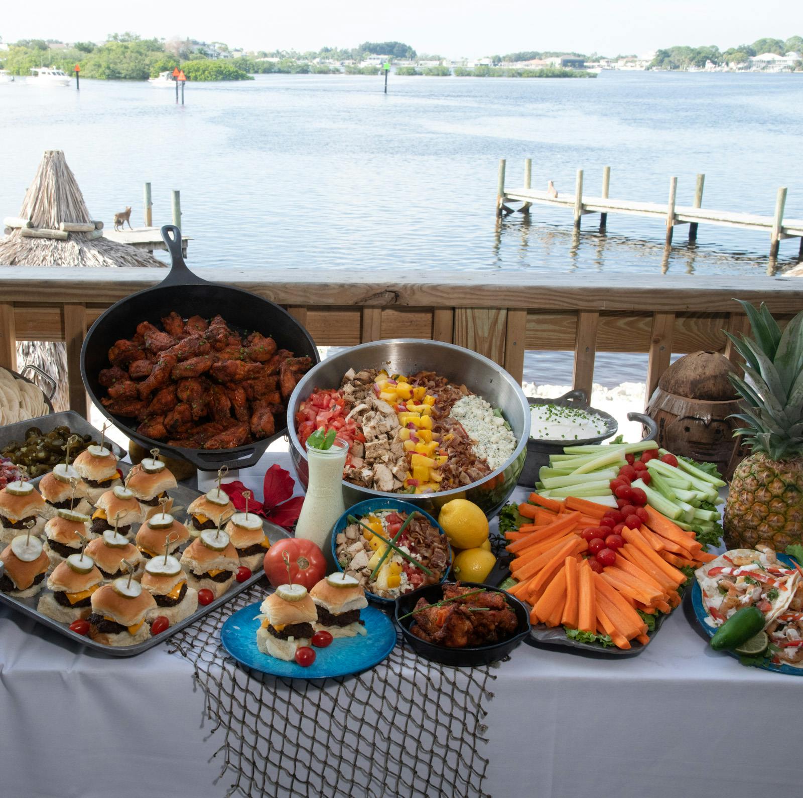 a person sitting at a table with food and water