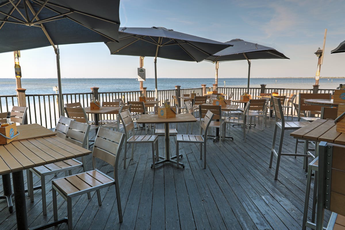 a deck with tables and umbrellas