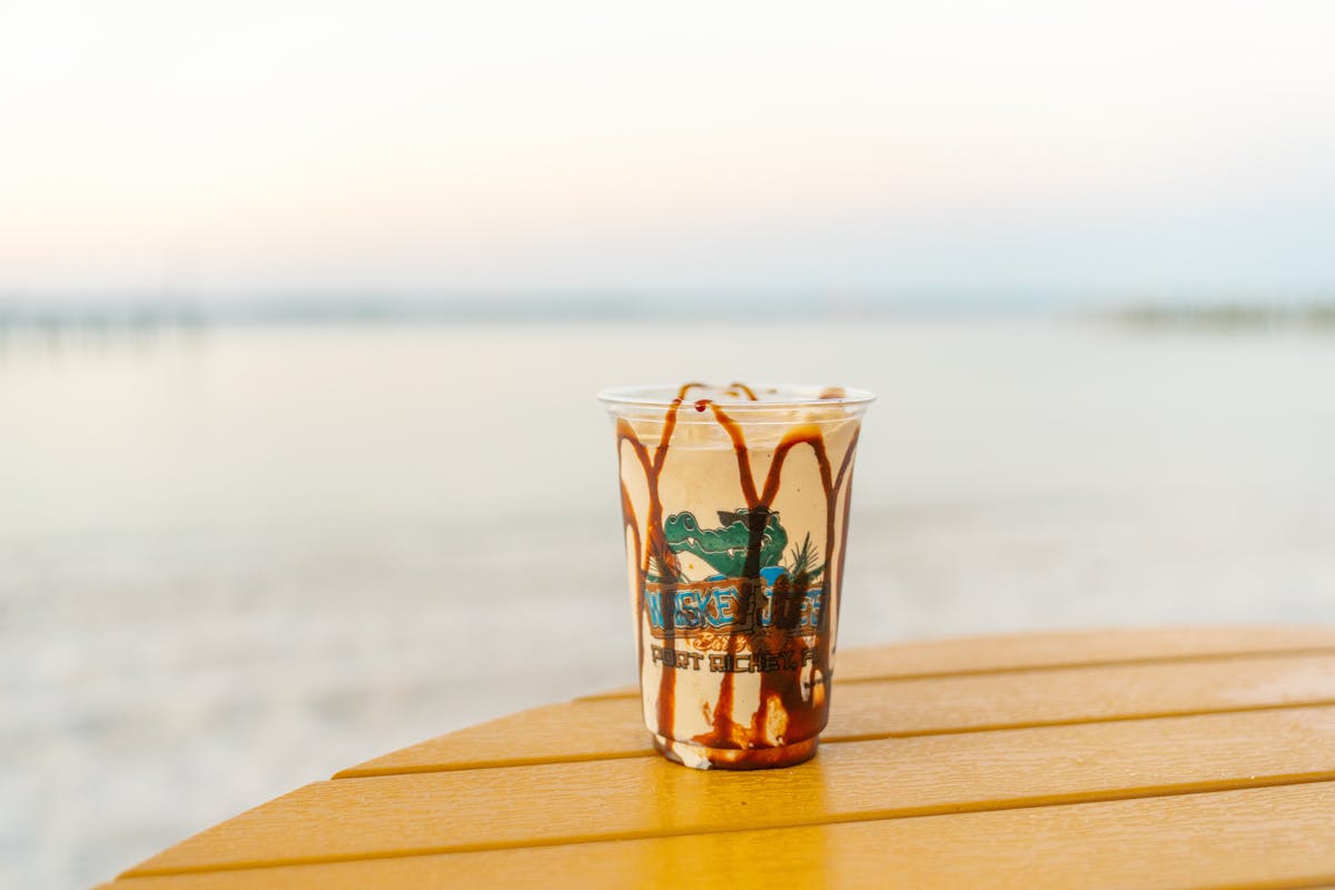 a cup of water on a beach