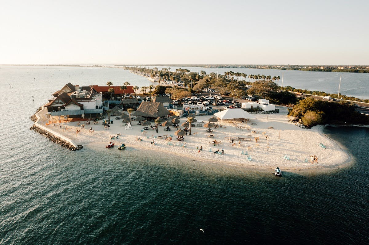 a group of people on a beach near a body of water