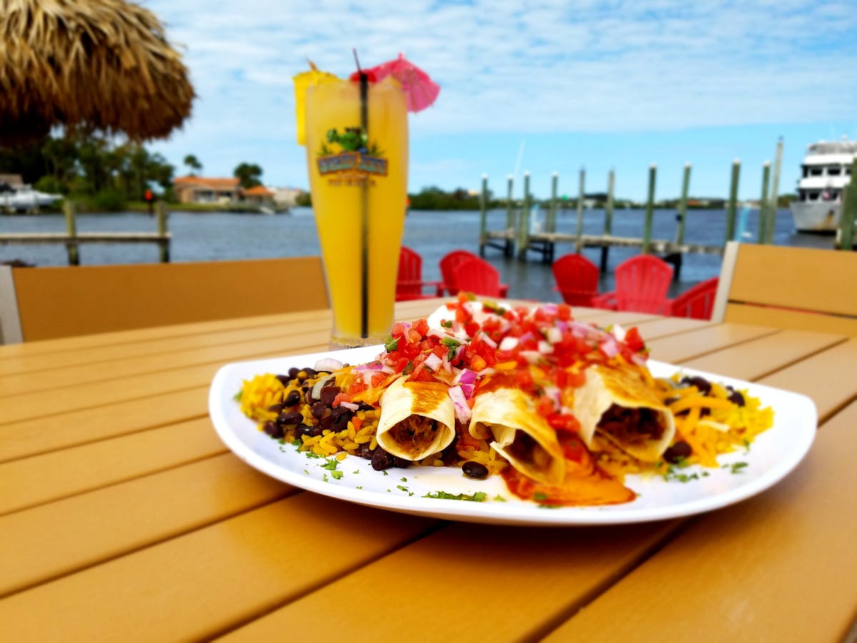 a plate of taquitos and cocktail