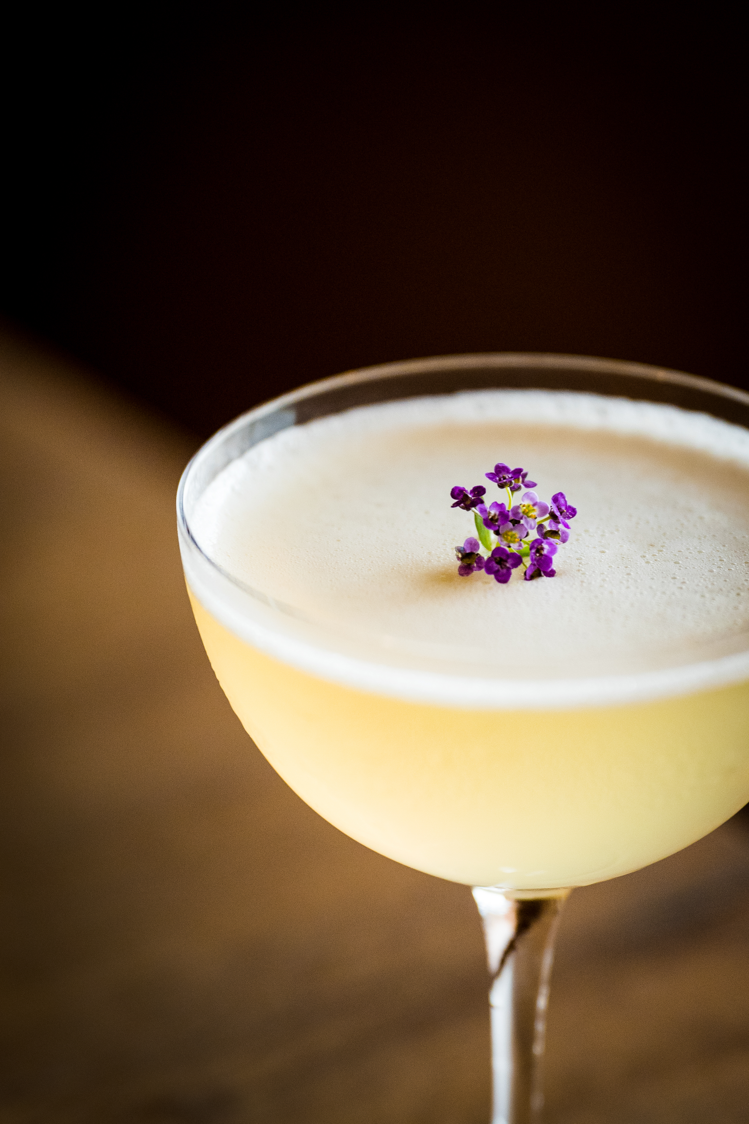 Full glass with small purple flowers on top