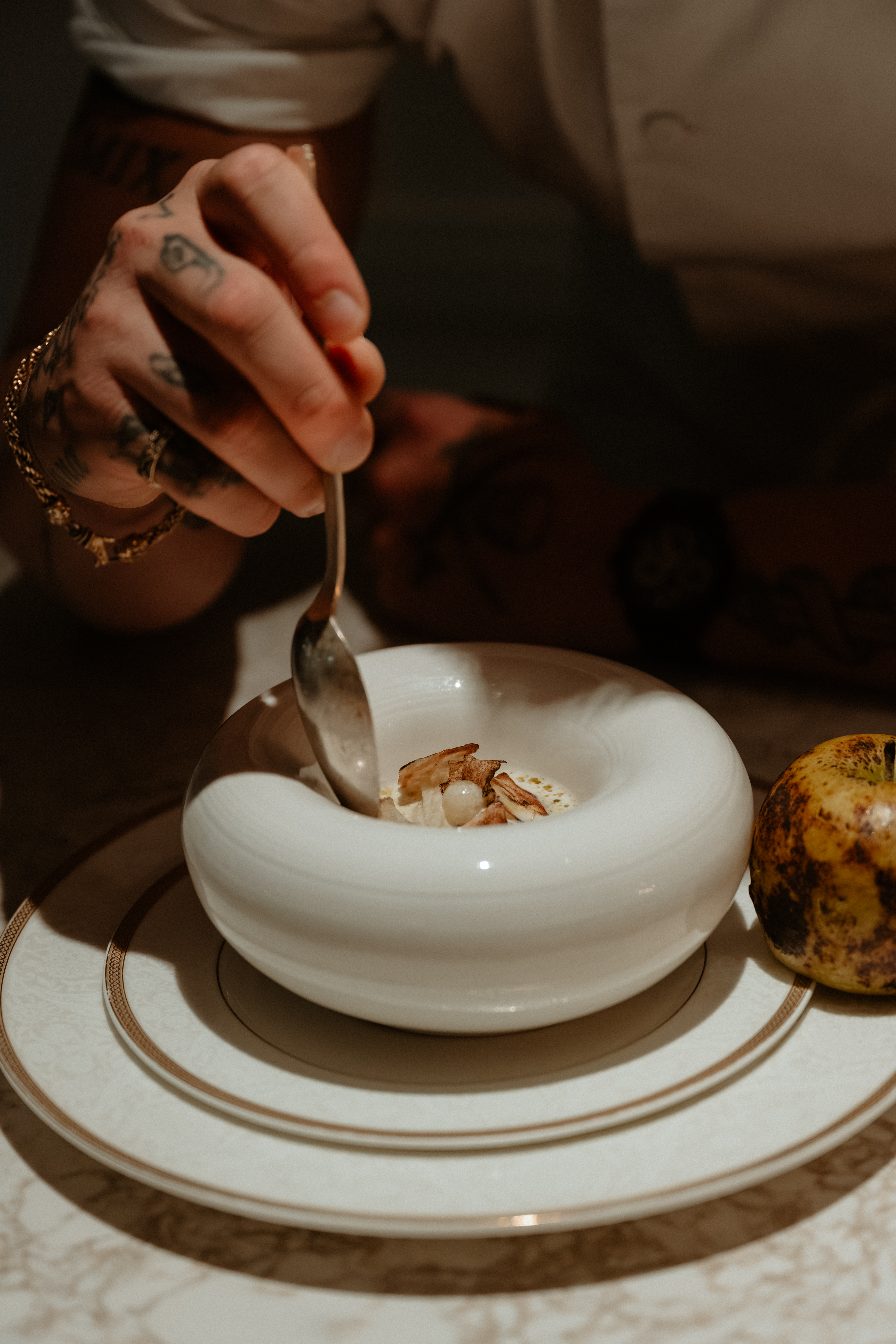 a person holding a piece of cake on a plate