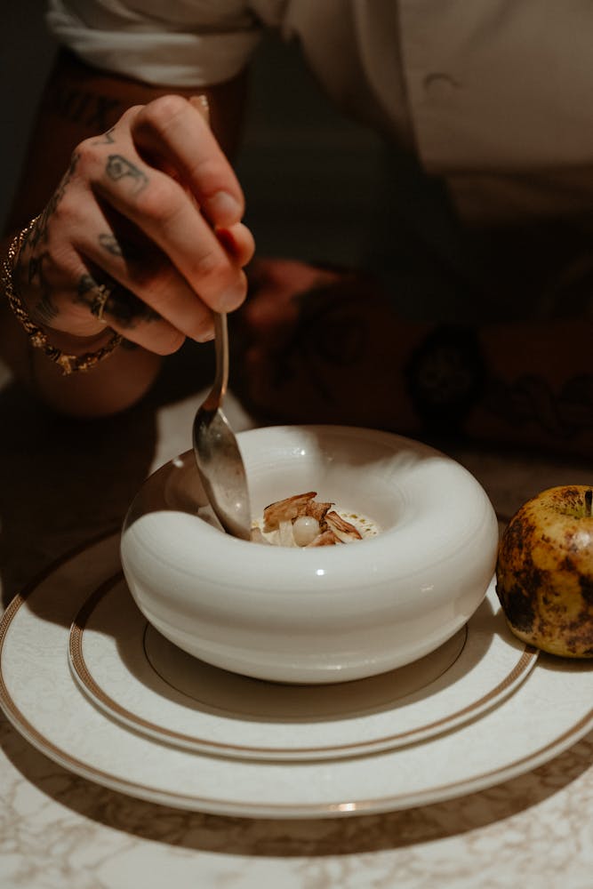 a person holding a piece of cake on a plate
