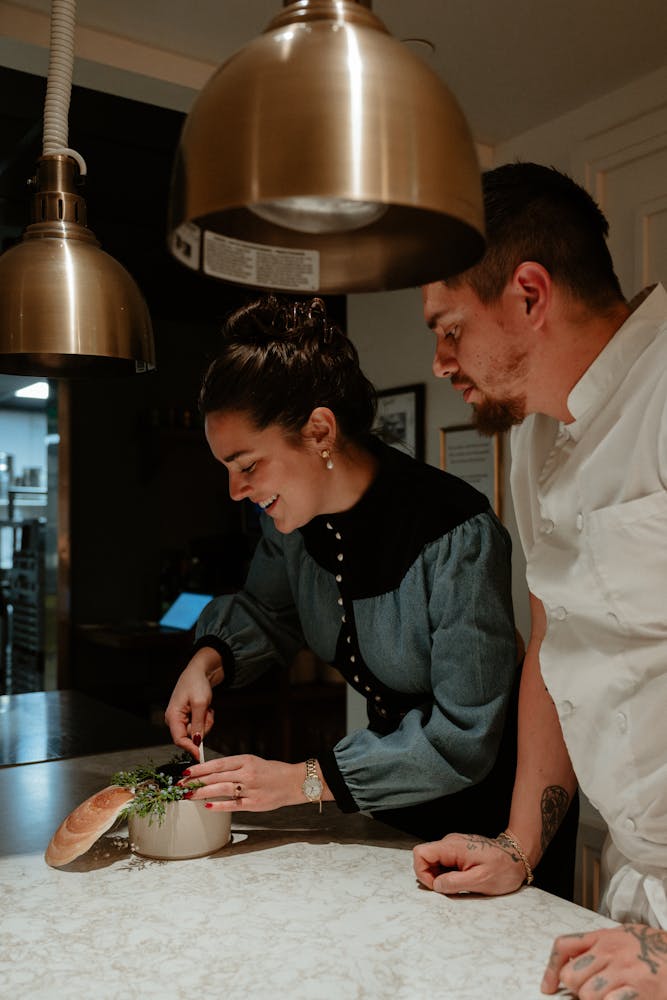 a man sitting on a cutting board with a cake