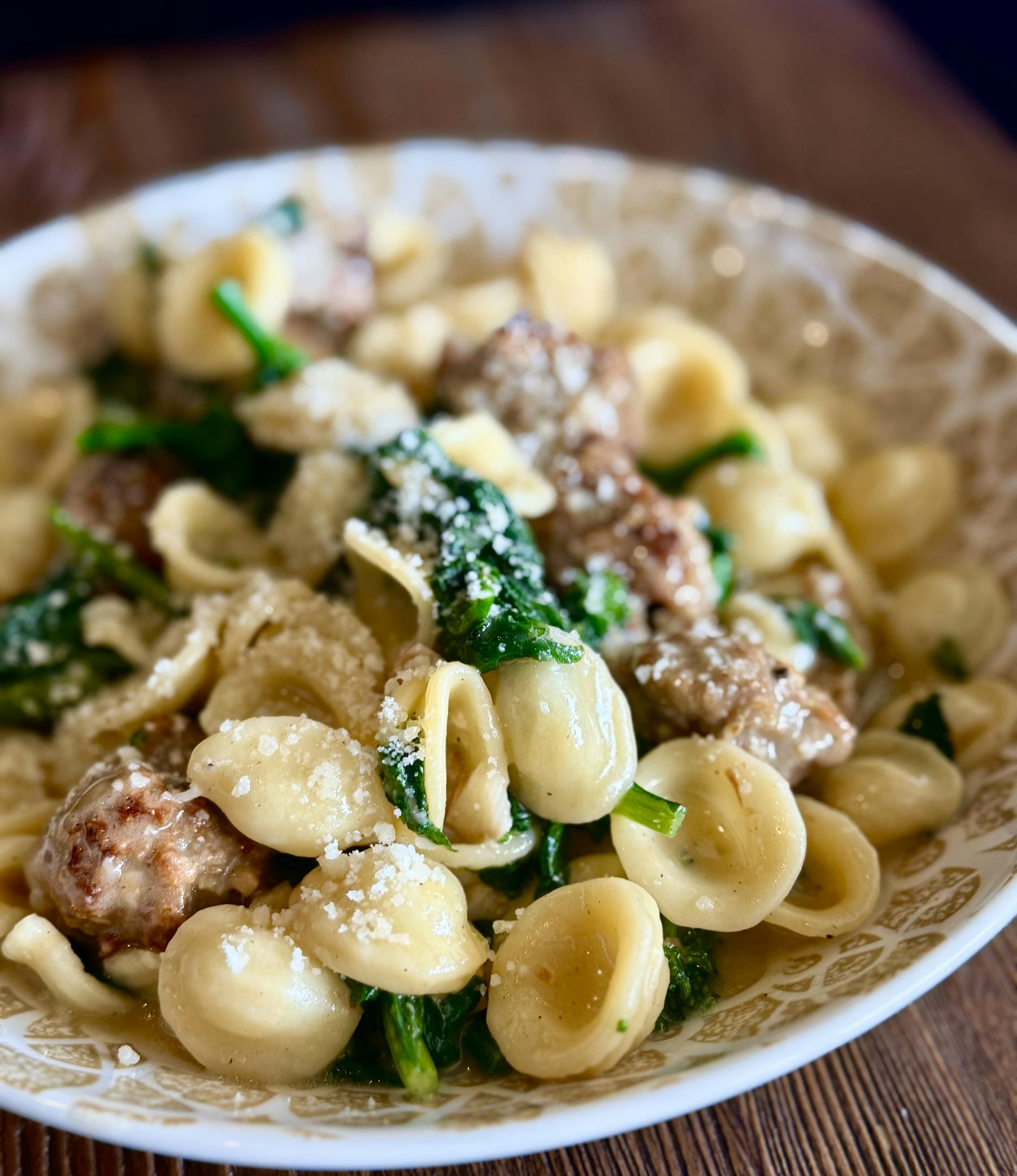 a plate of pasta with cheese on top