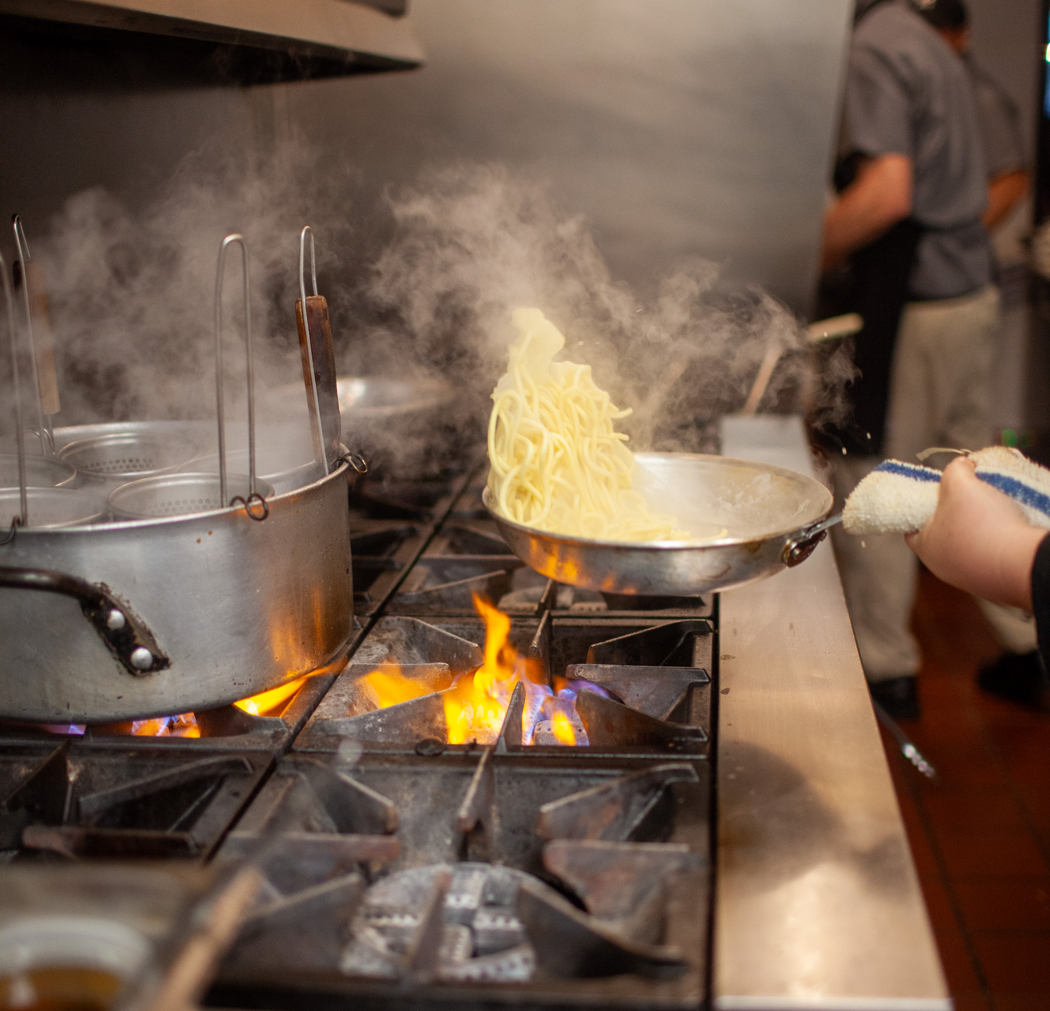 a person cooking in a kitchen preparing food