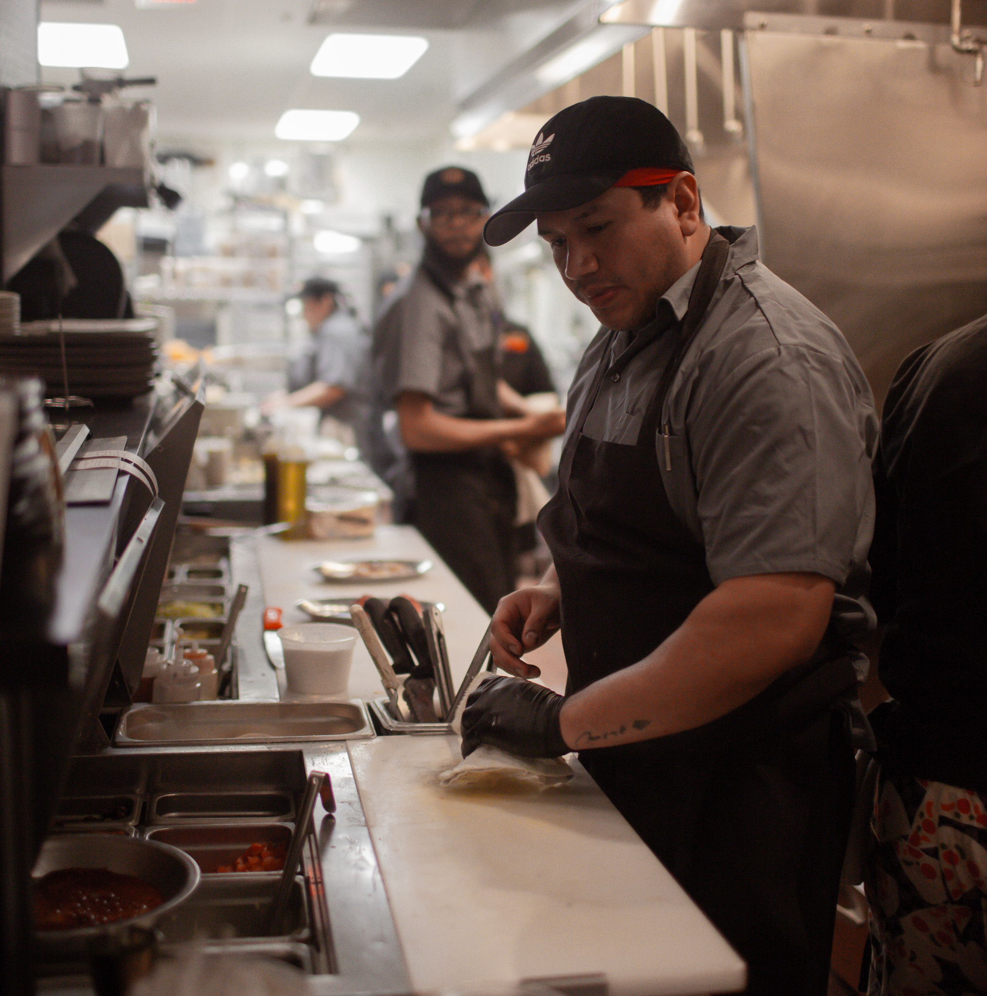 a group of people preparing food in a kitchen