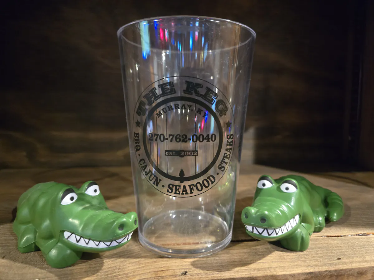 a plastic cup with a couple of alligators on it