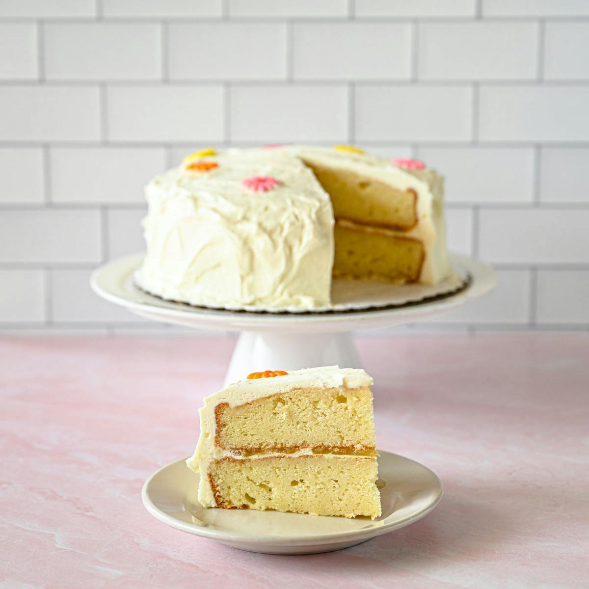 a person sitting at a table with a cake on a plate