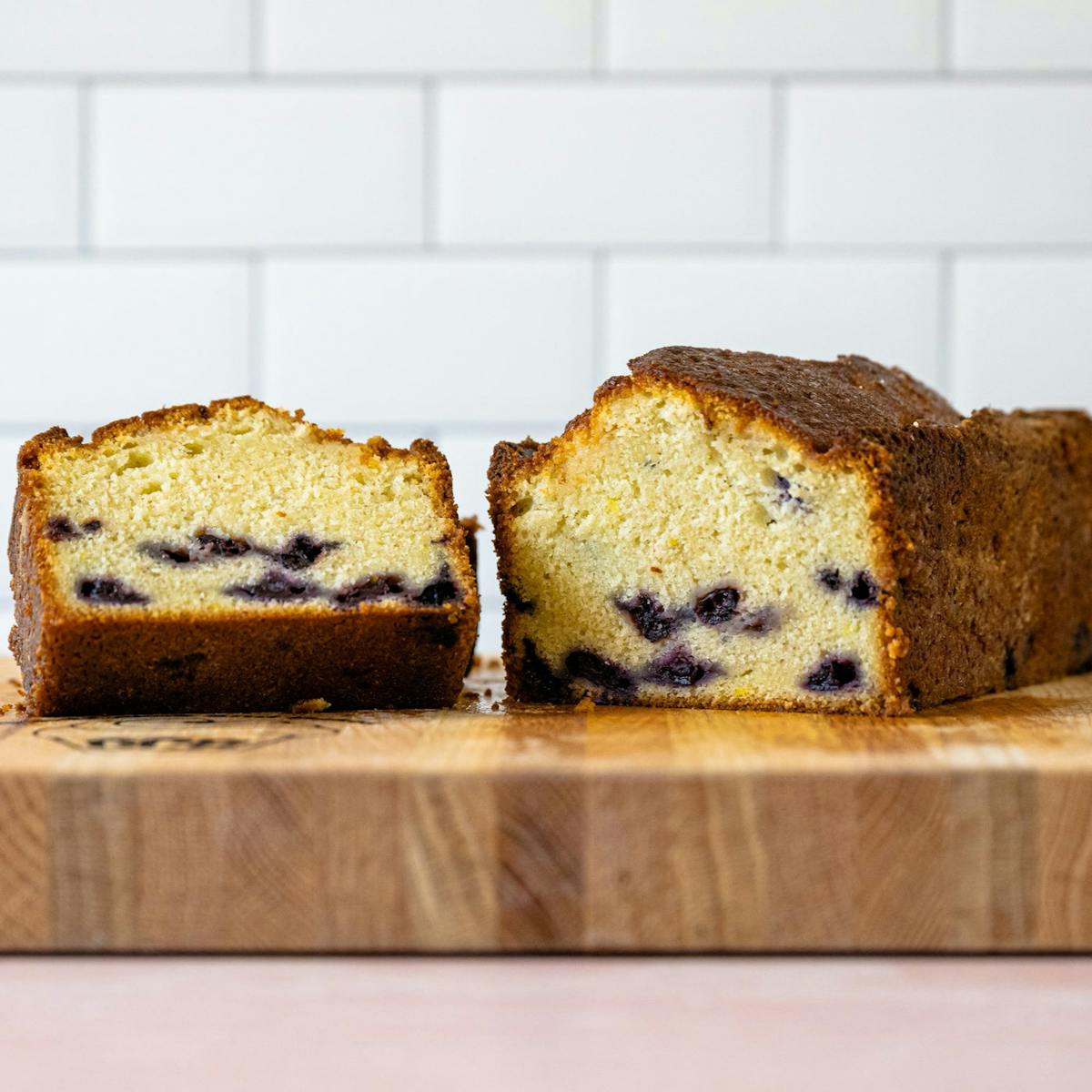 a piece of bread on a cutting board with a cake