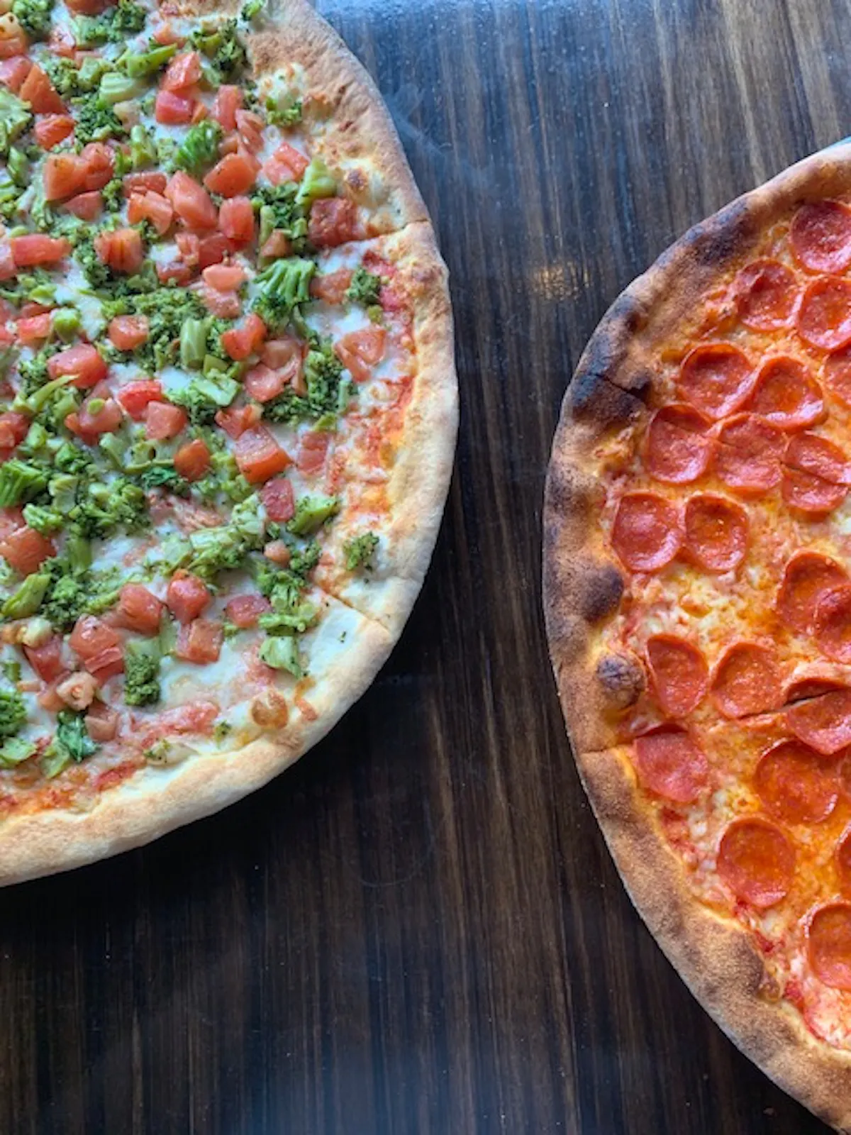 a pizza sitting on top of a wooden table