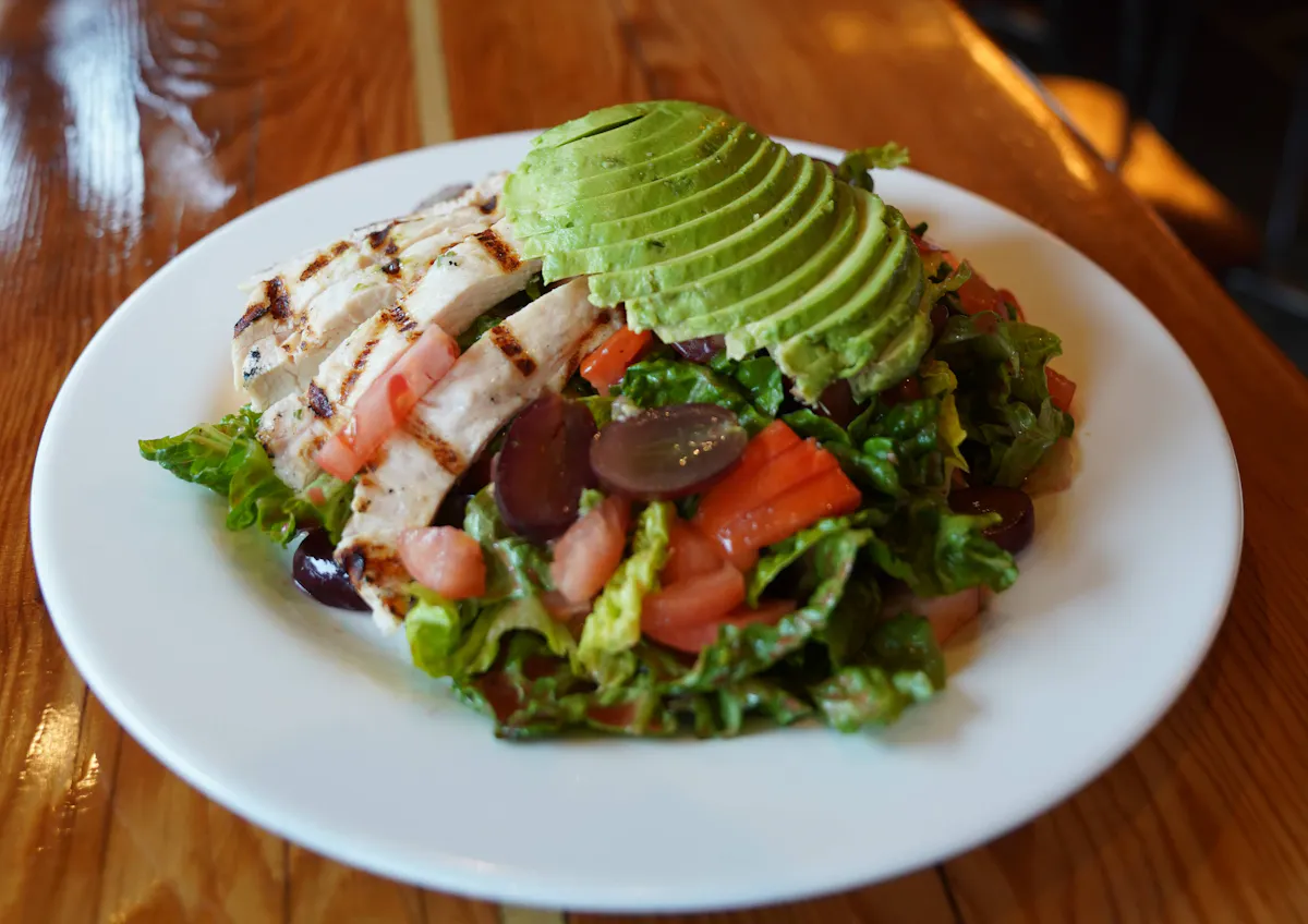 a white plate topped with meat and vegetables