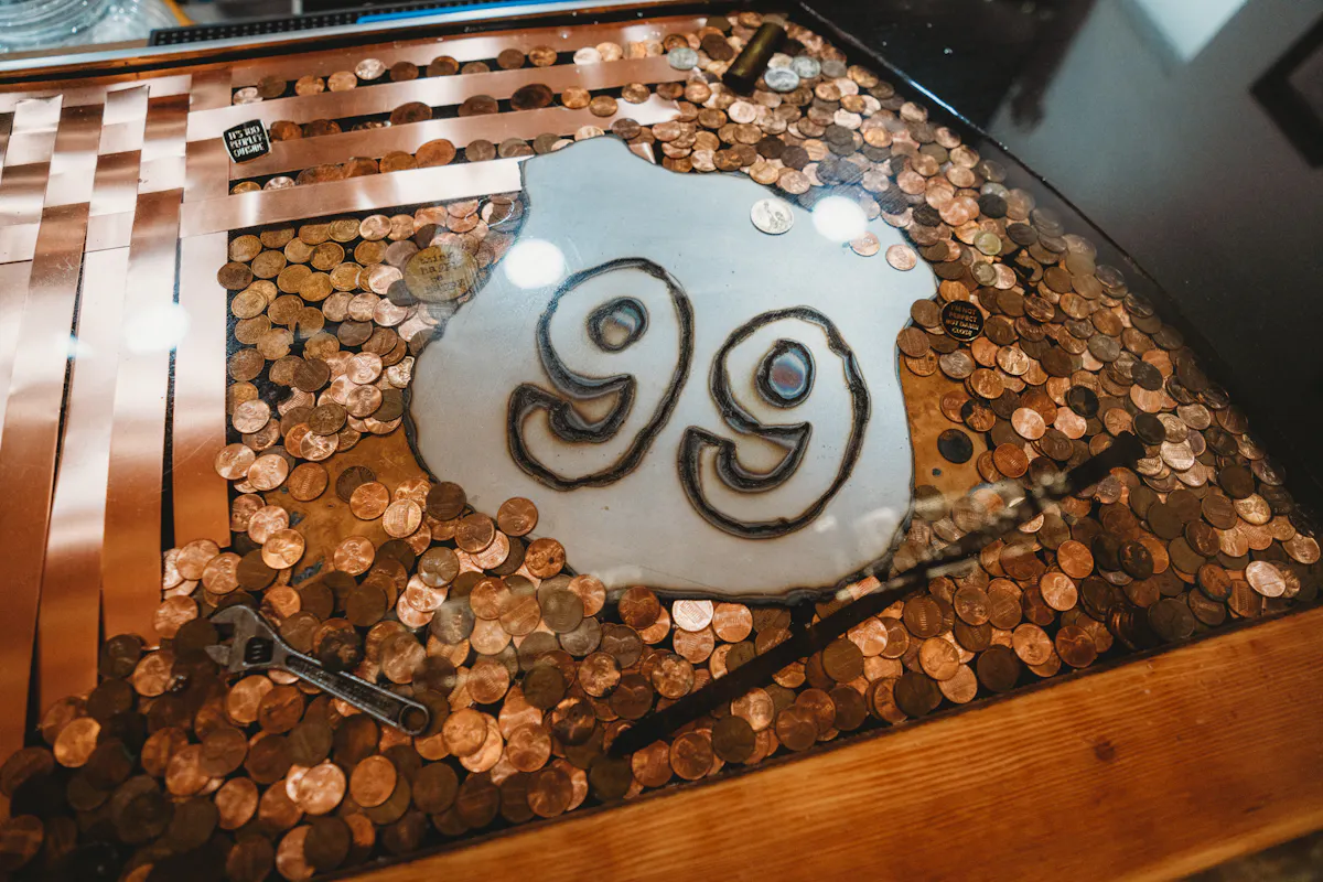 a table with coins and a sign
