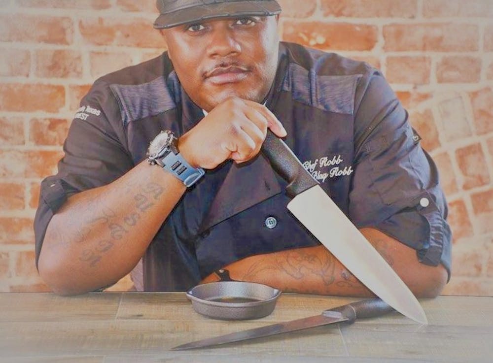 a man sitting on a cutting board