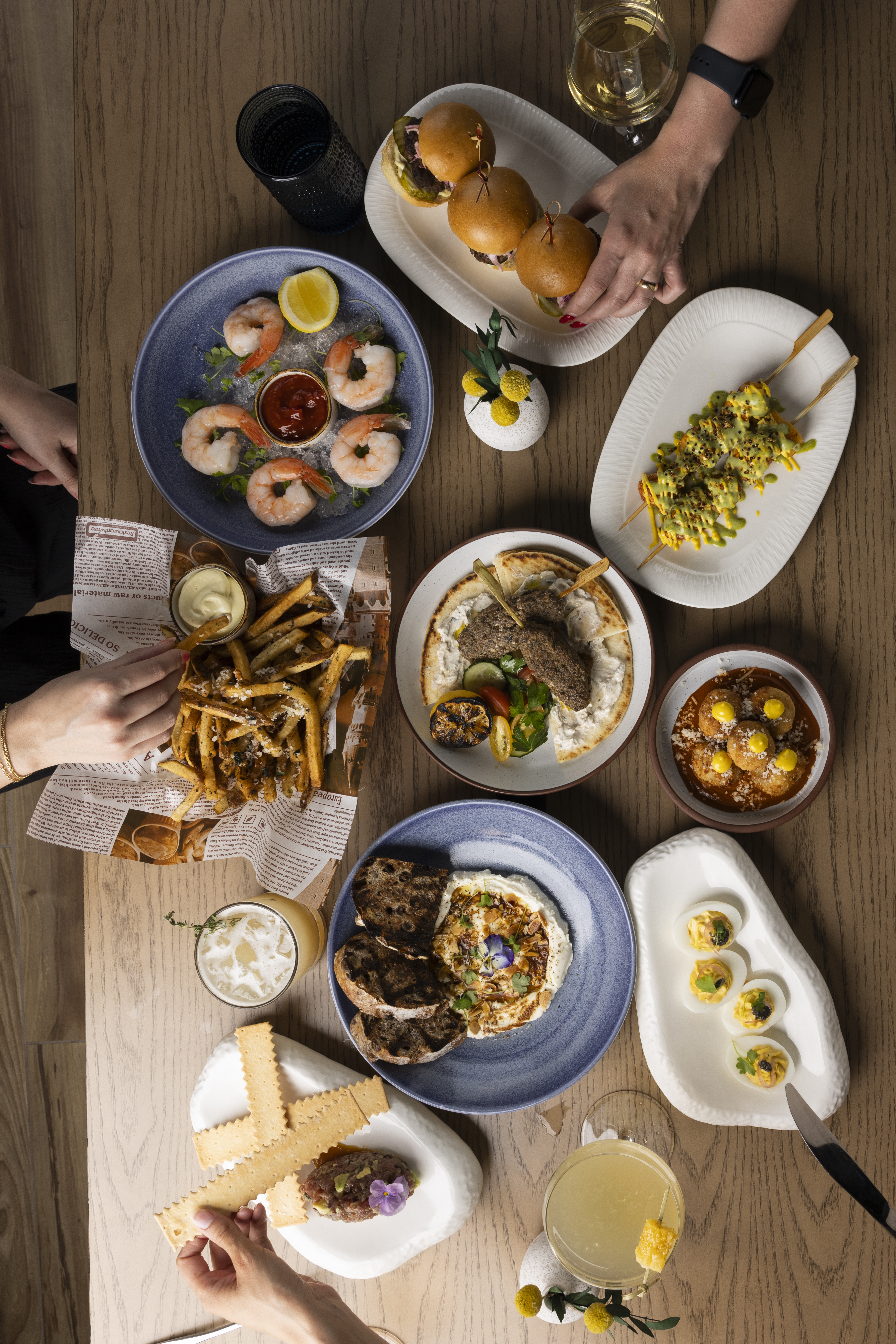 a group of people sitting at a table with a plate of food