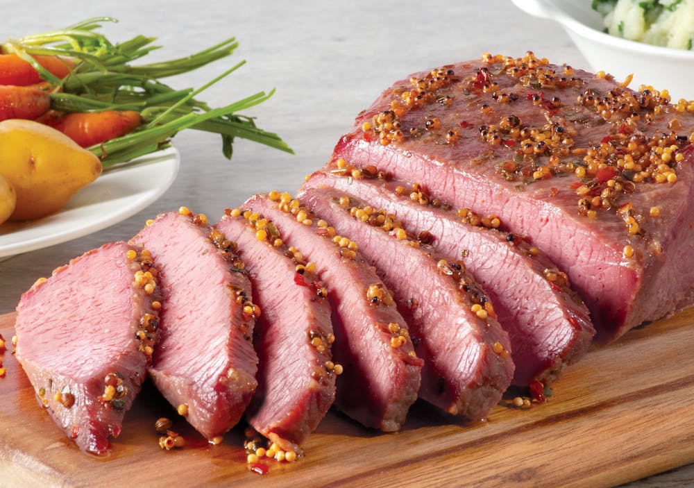 a plate of food with meat and vegetables on a cutting board