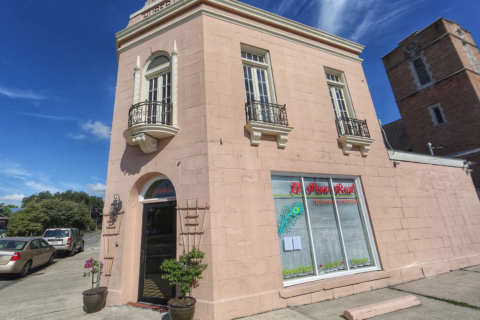 a clock tower in front of a brick building