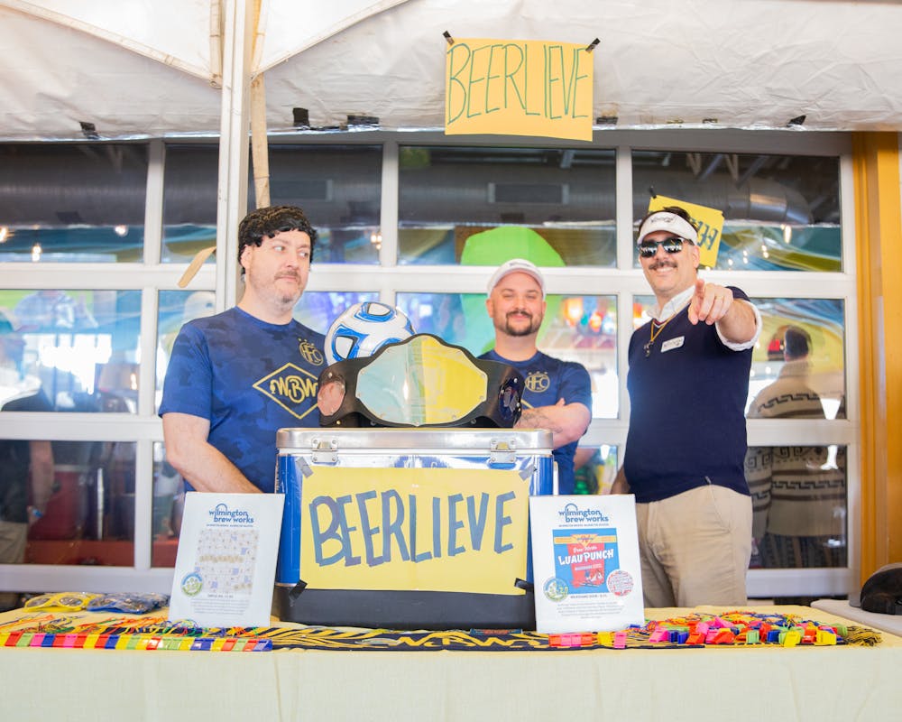 a group of people standing in front of a store