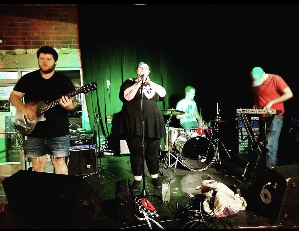 a band on stage at Crown Station