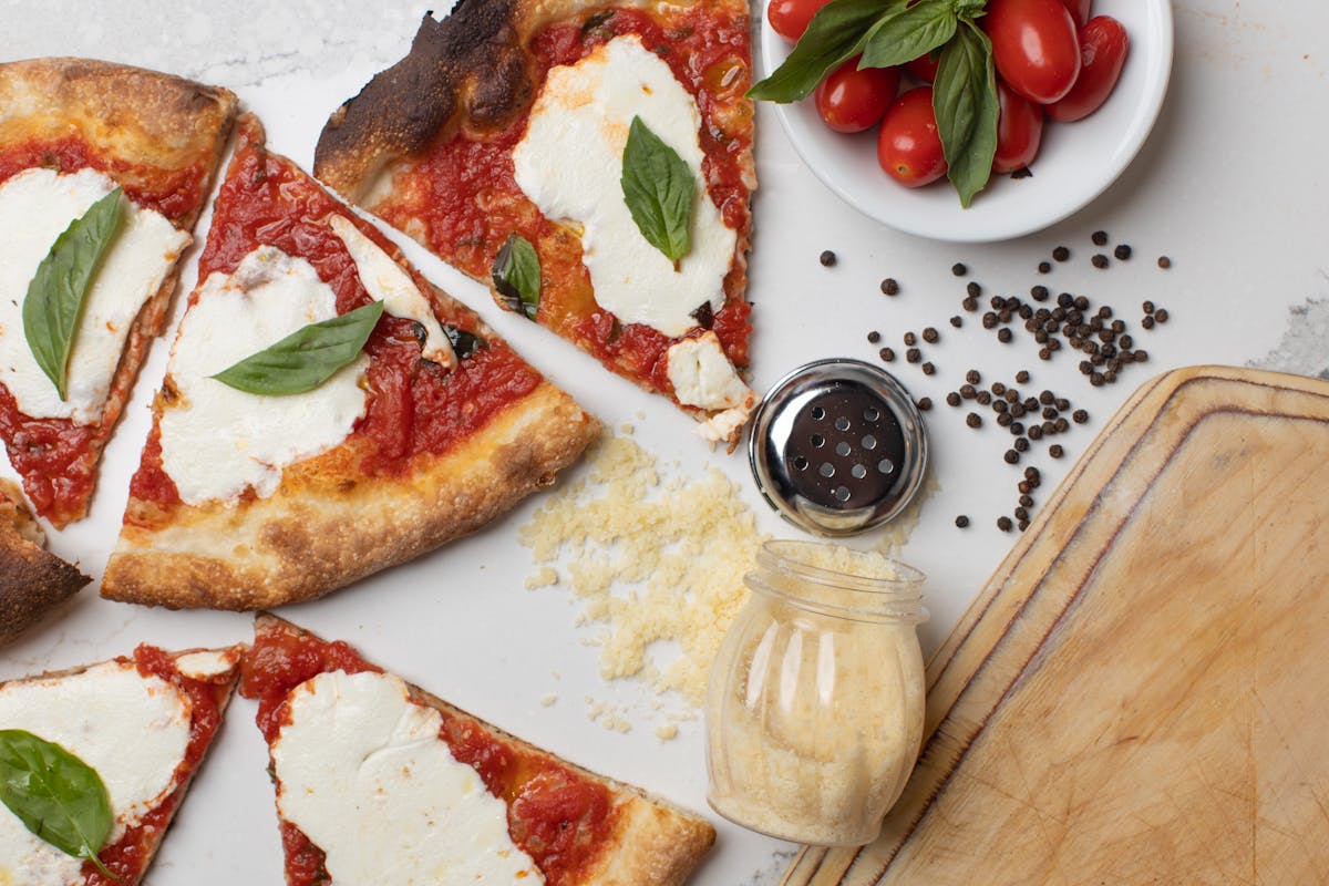 a plate of food with a slice of pizza