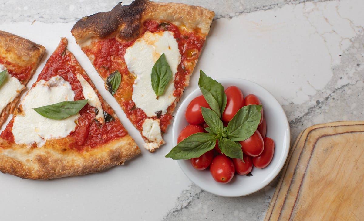 a plate of food with a slice of pizza