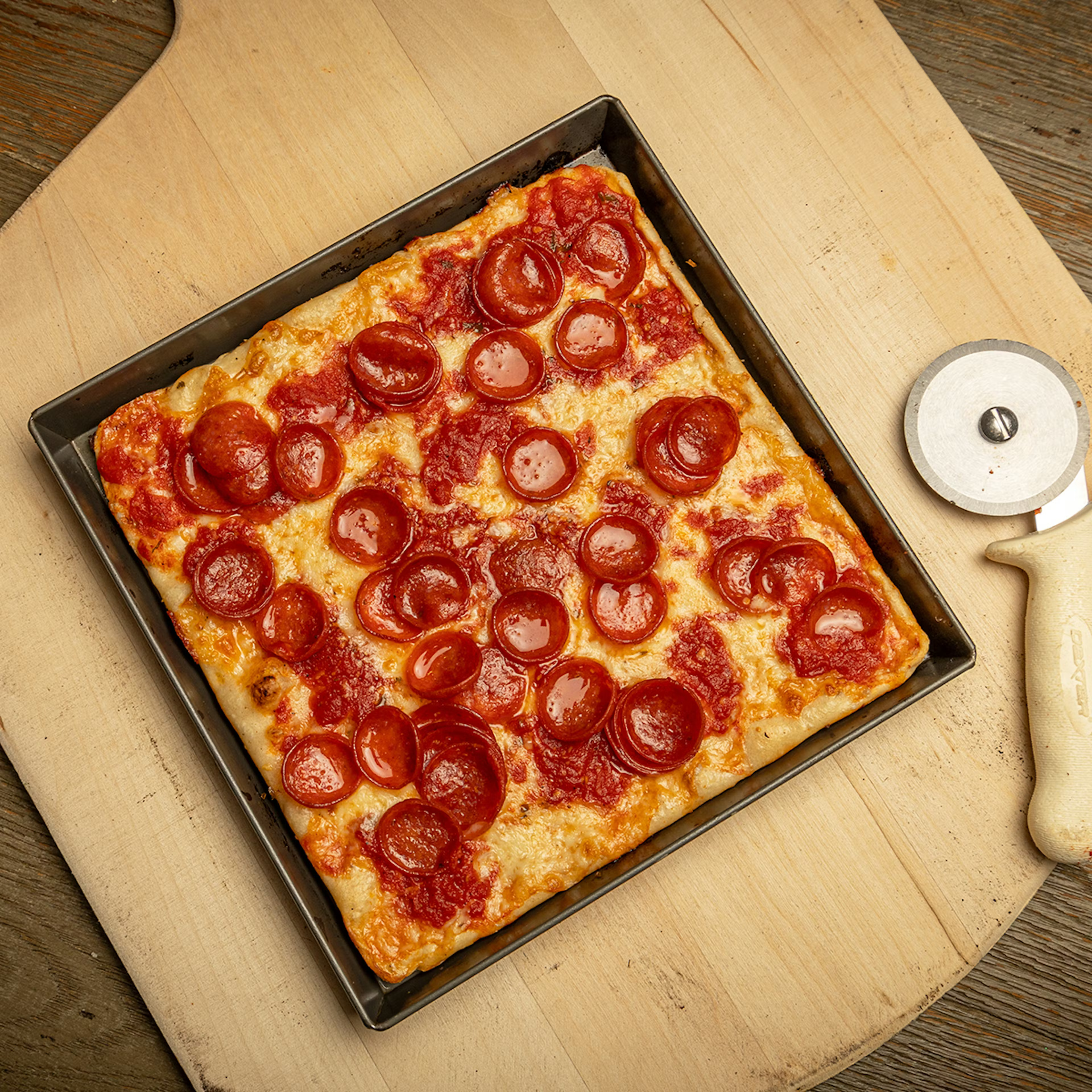 a pizza on a cutting board