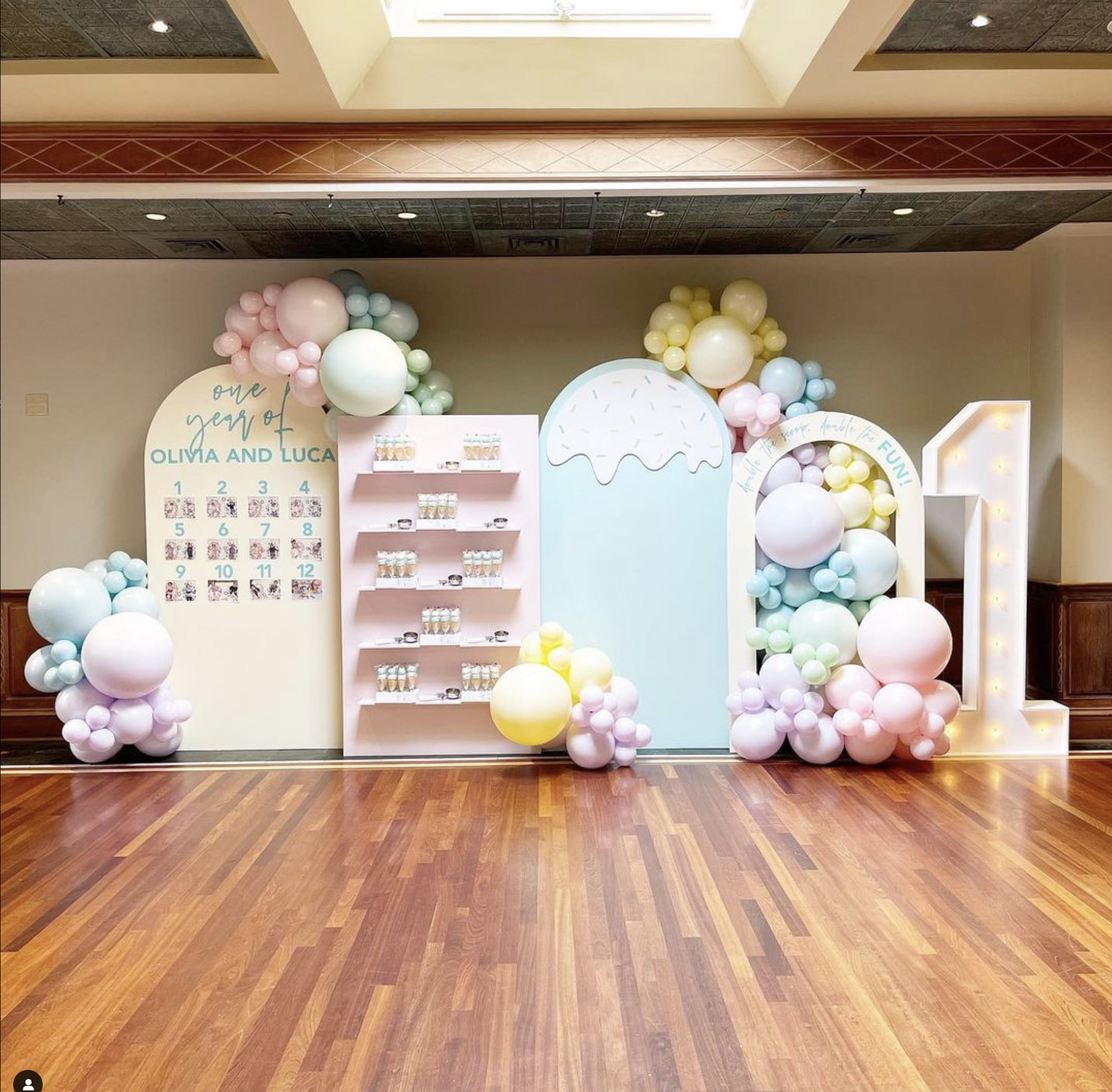 a room with balloons and a wood floor