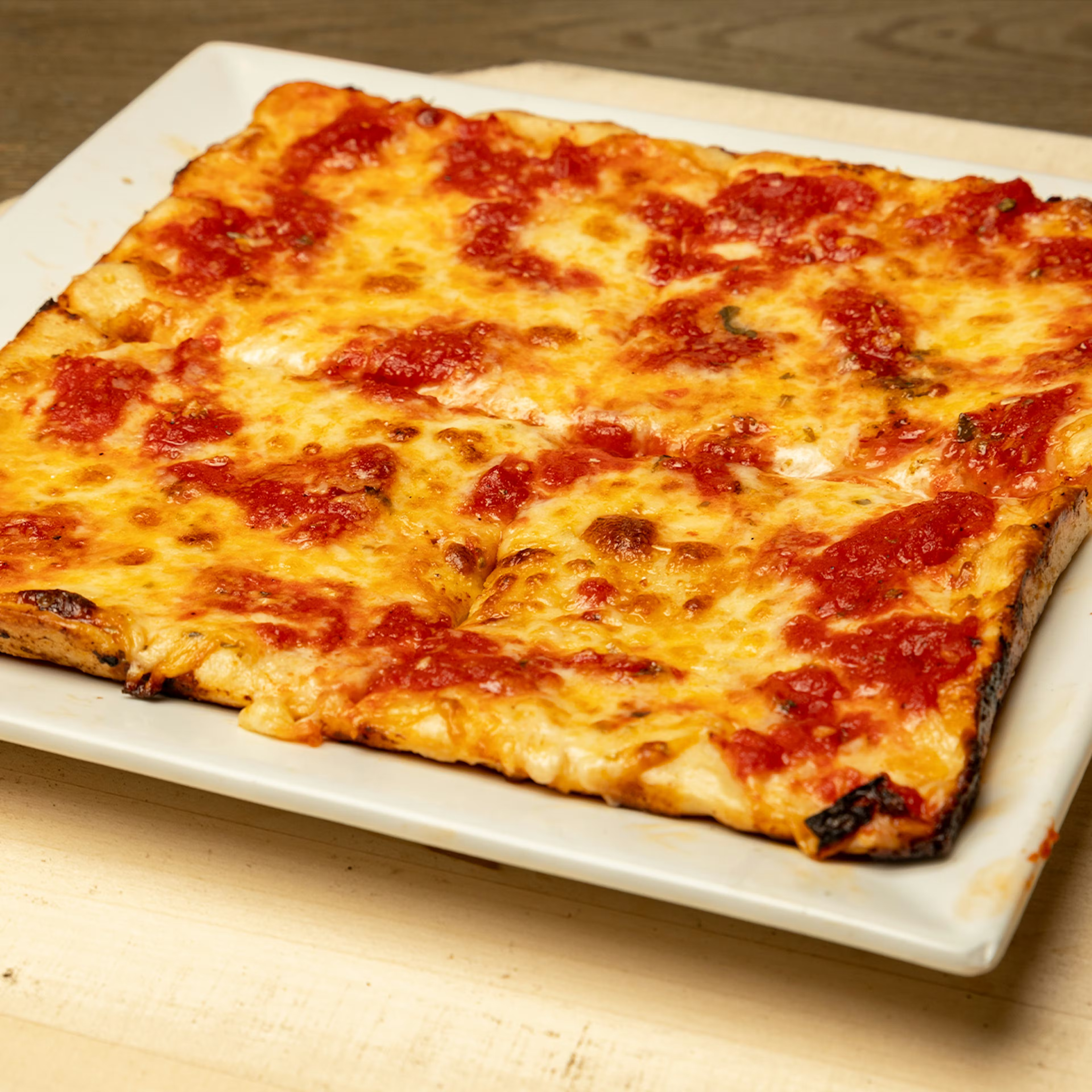 a square pizza on a plate