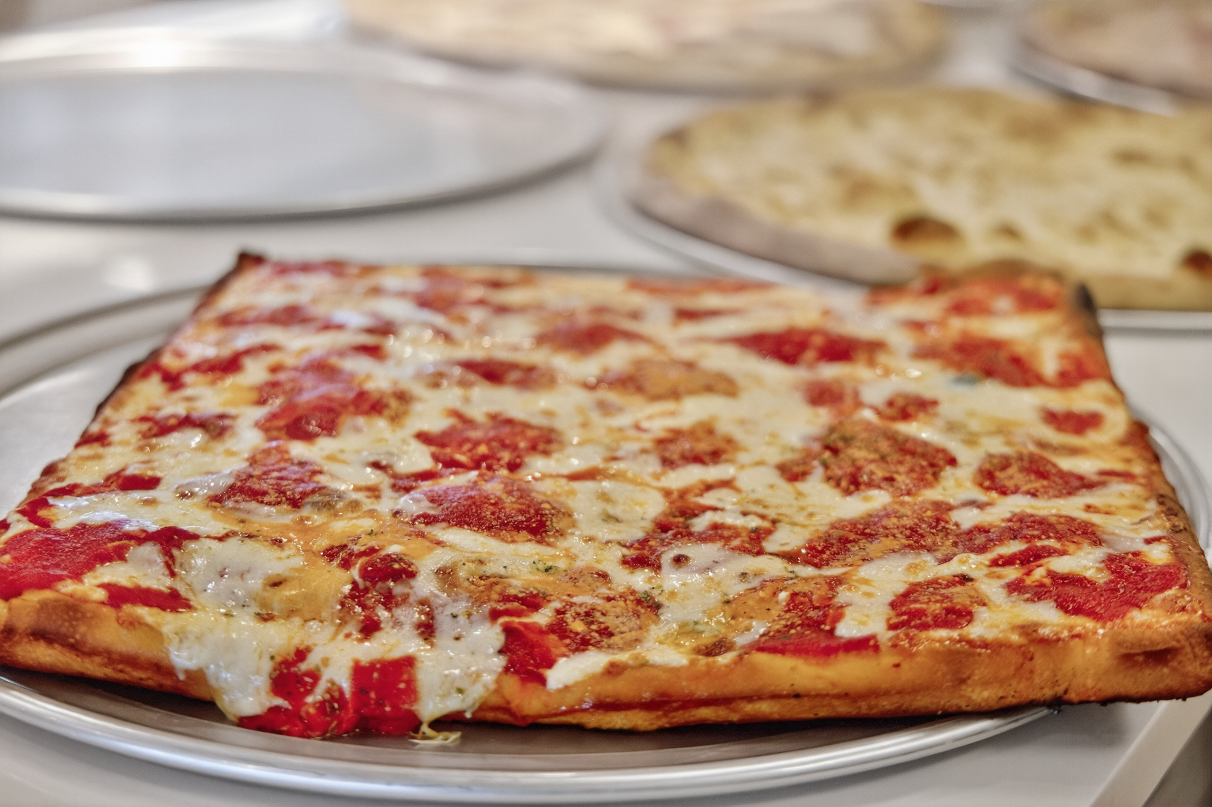 a square pizza on a plate