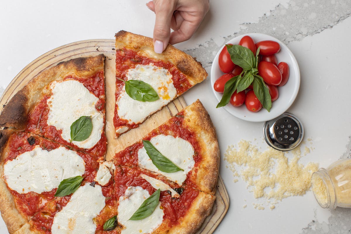 a plate of food with a slice of pizza