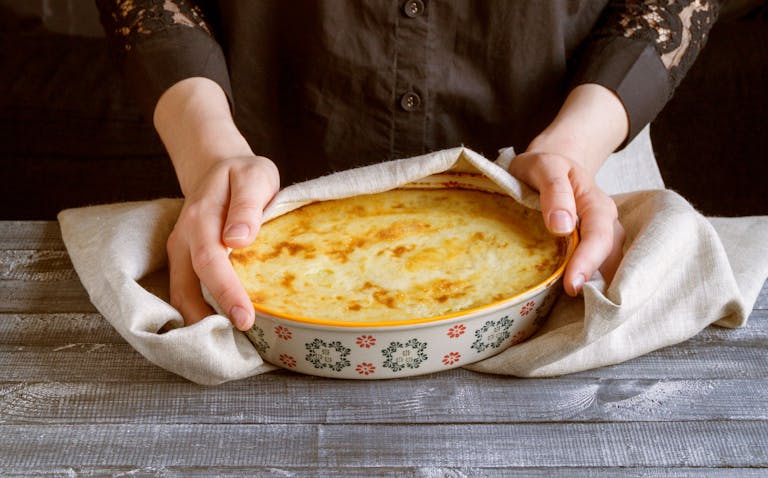 a person holding a bowl of food