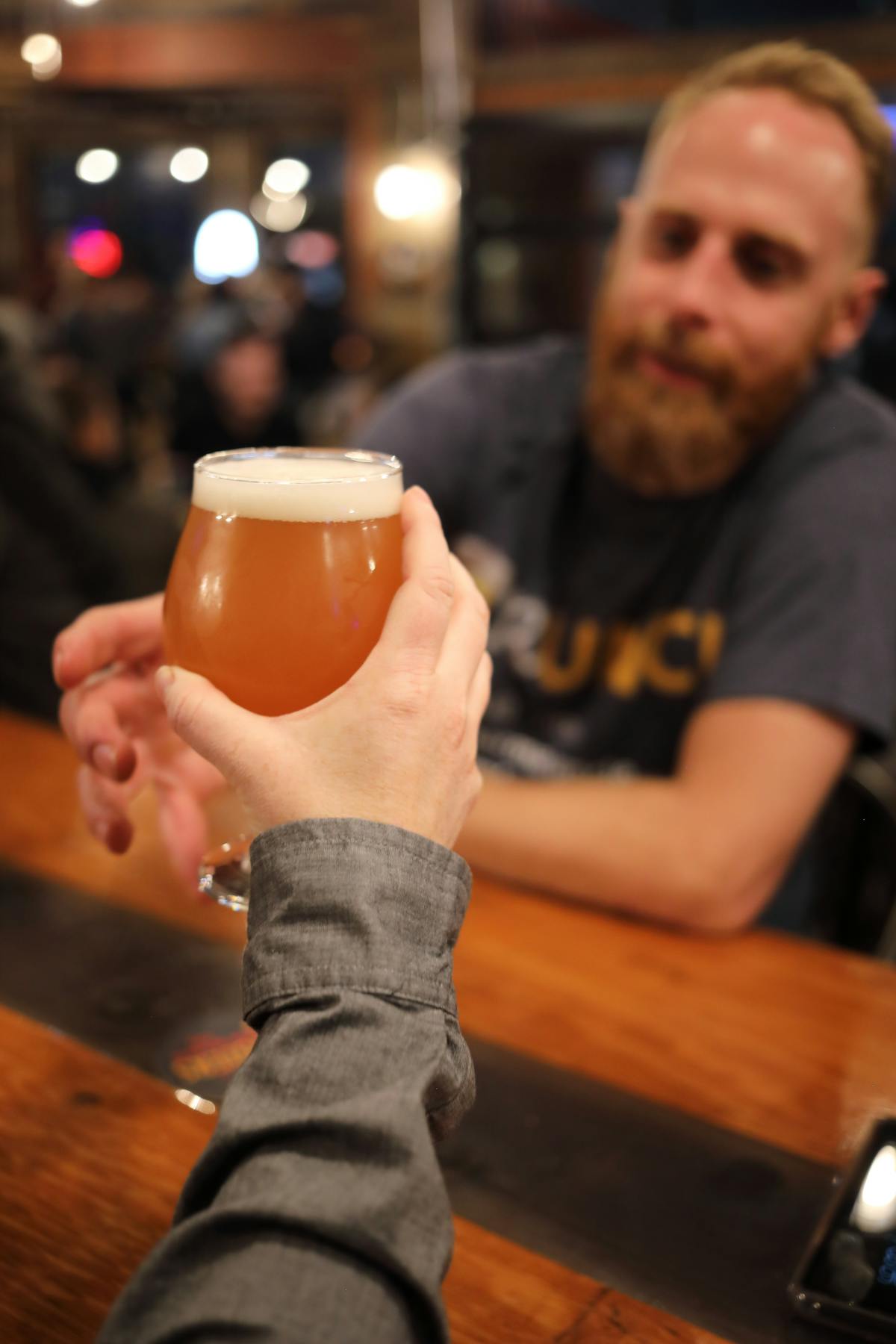 Bartender serving Ogden Double IPA to a guest