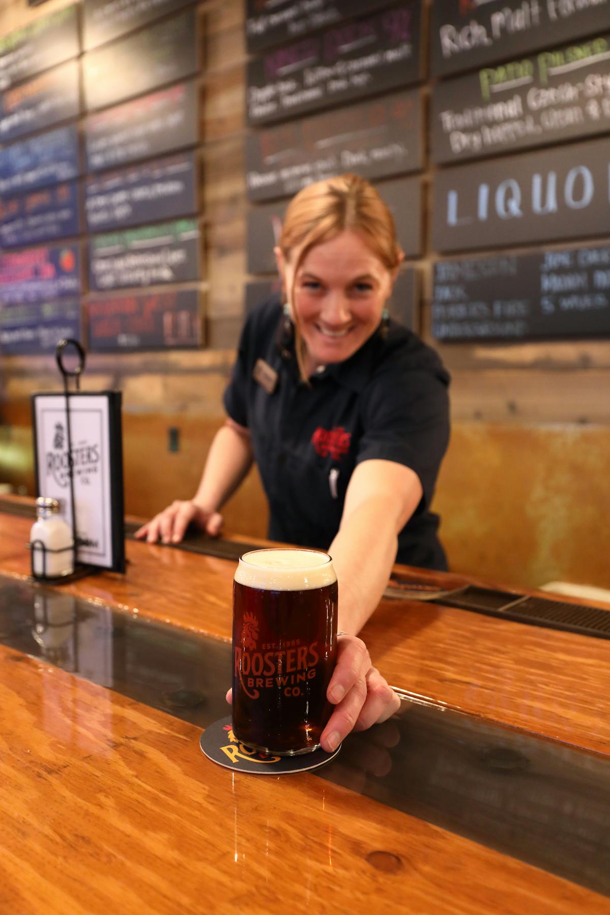 Bartender serving a pint of B Street Blackberry Cream Ale
