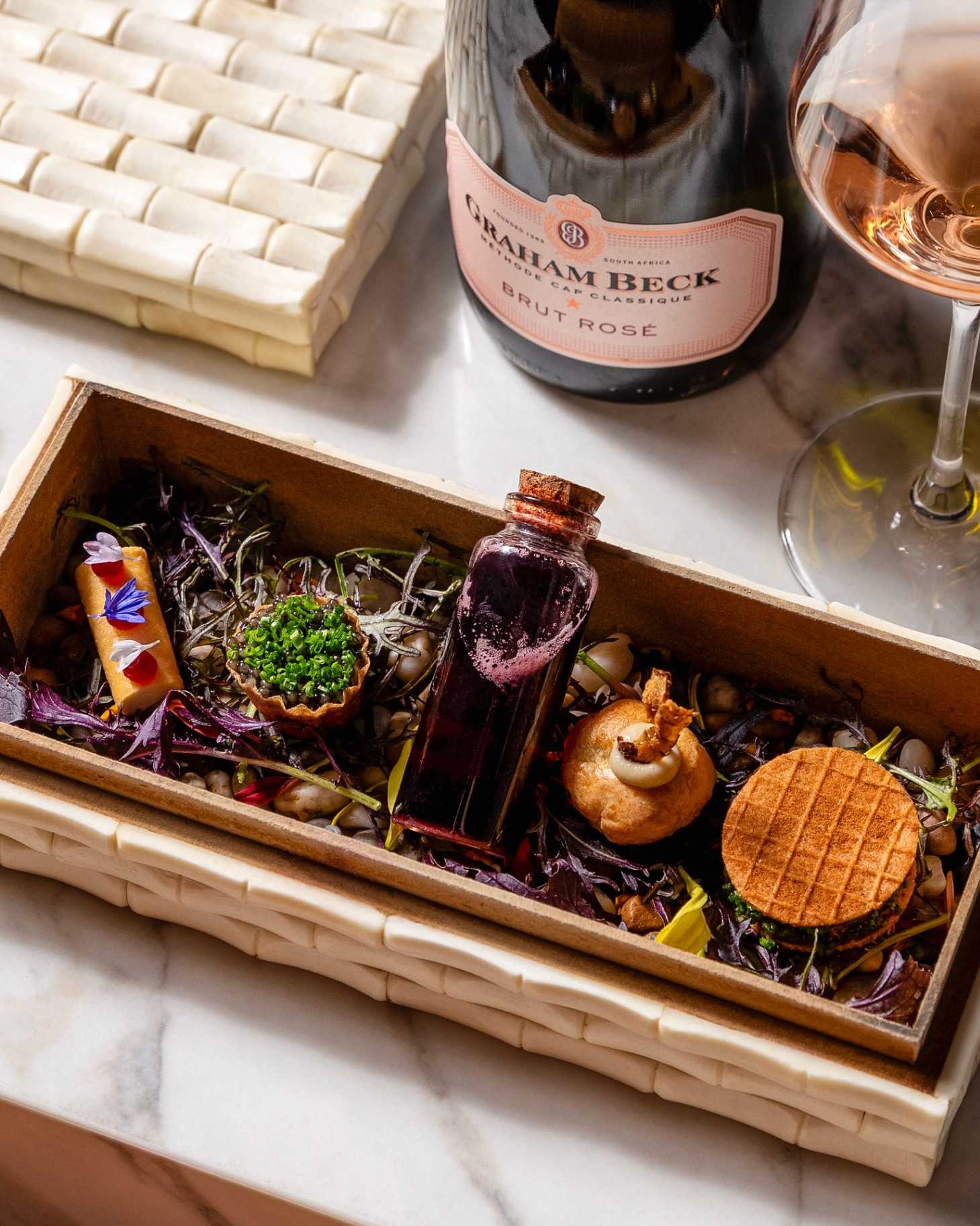 a box with food in it and a bottle of wine