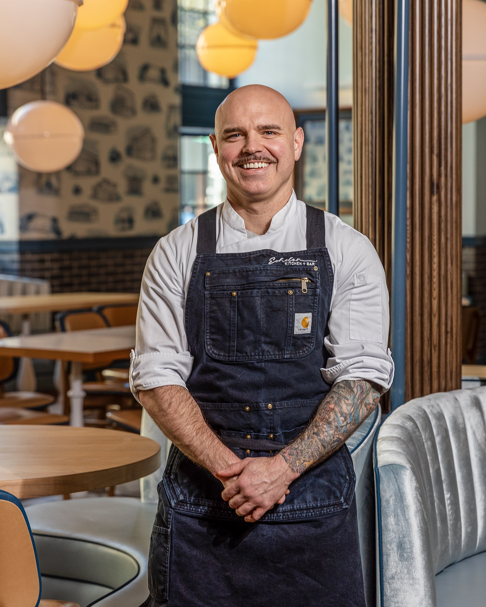 a man in overalls smiling