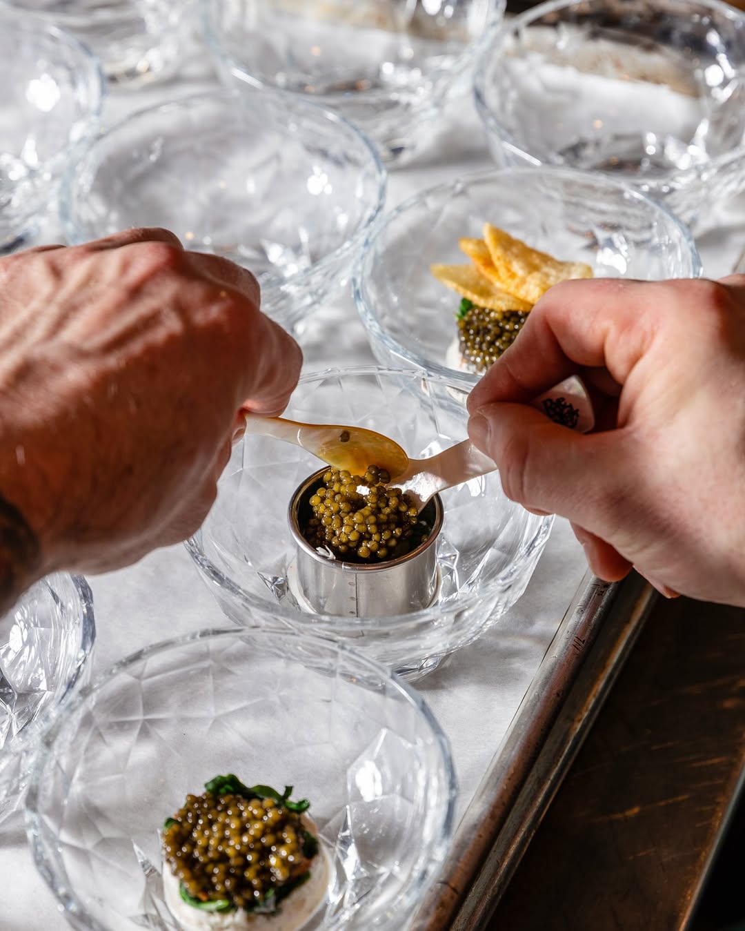 a person putting a spoon into a bowl of food