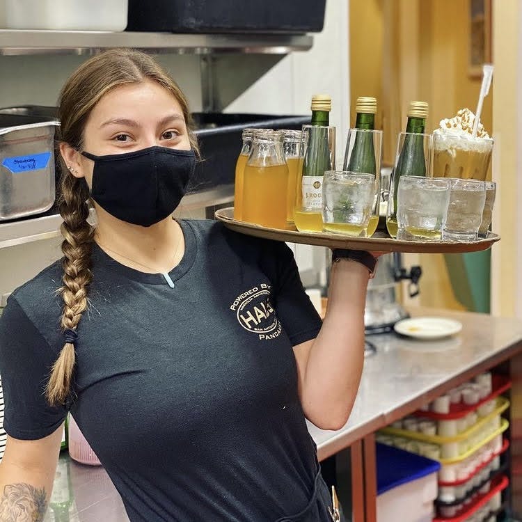 a woman drinking from a glass