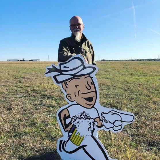 a man holding a kite in a field