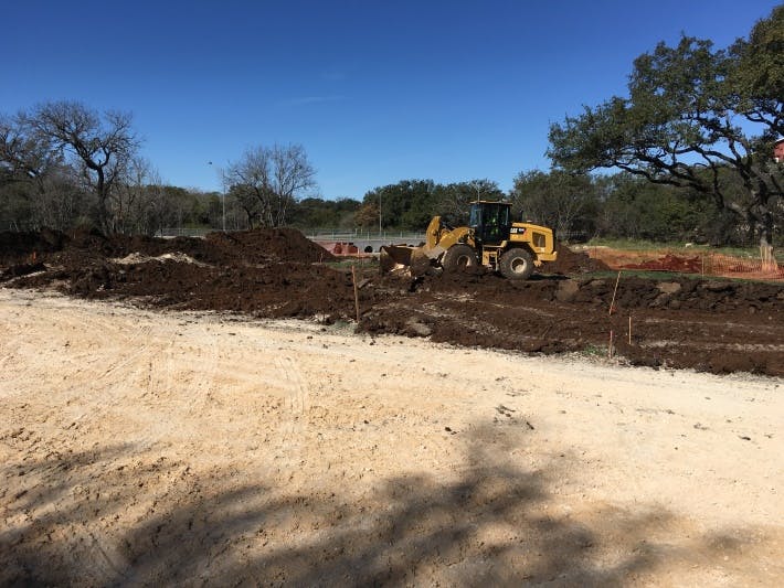 a truck driving down a dirt road