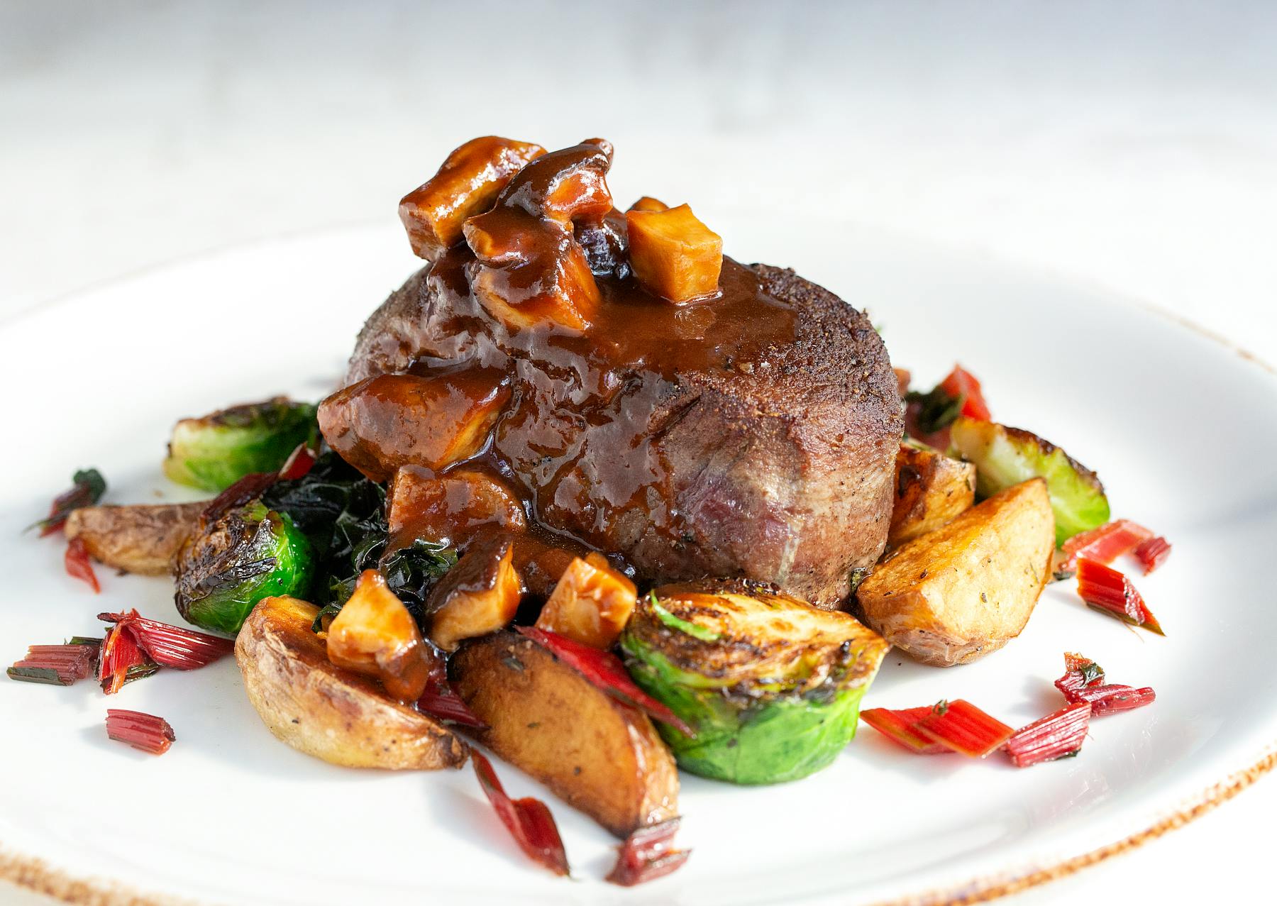 a white plate topped with meat and vegetables