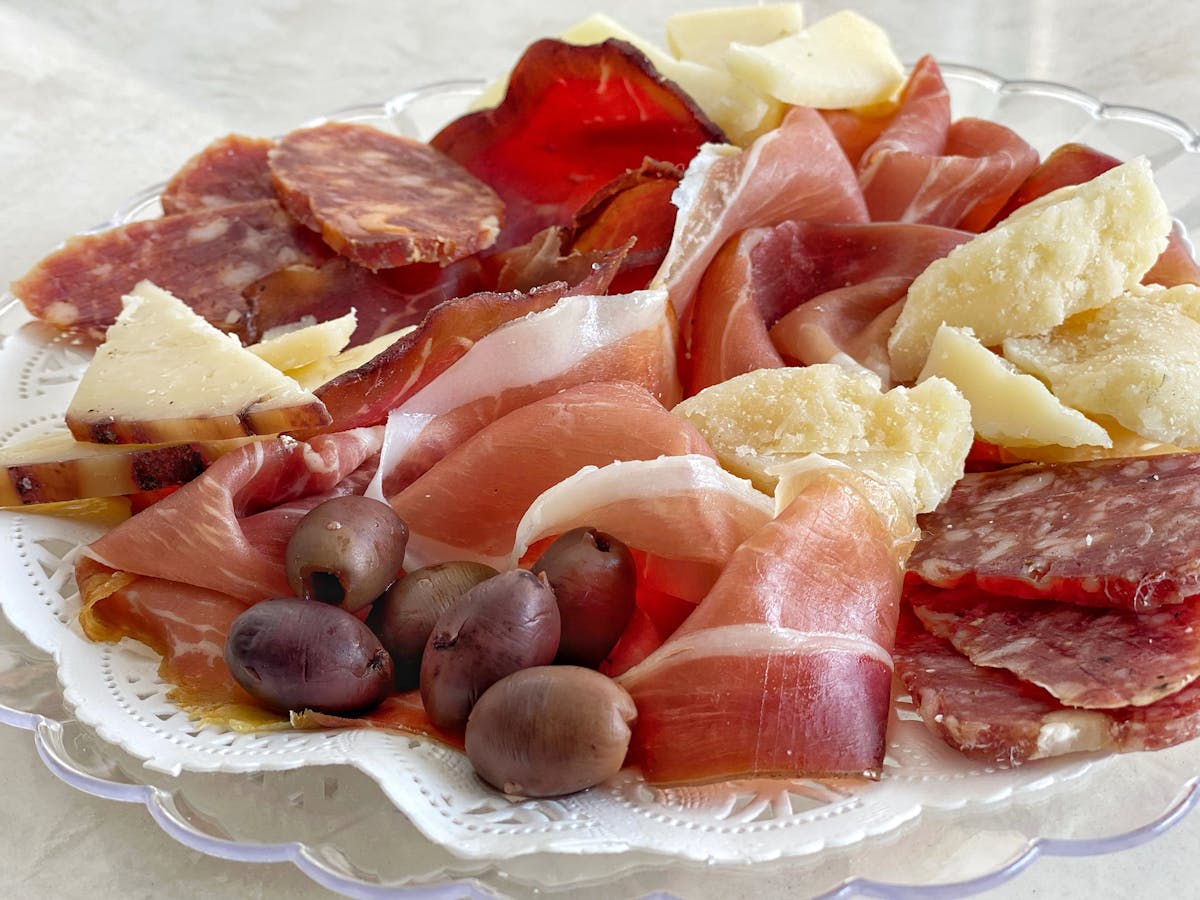 a plate of food with a slice of fresh fruit