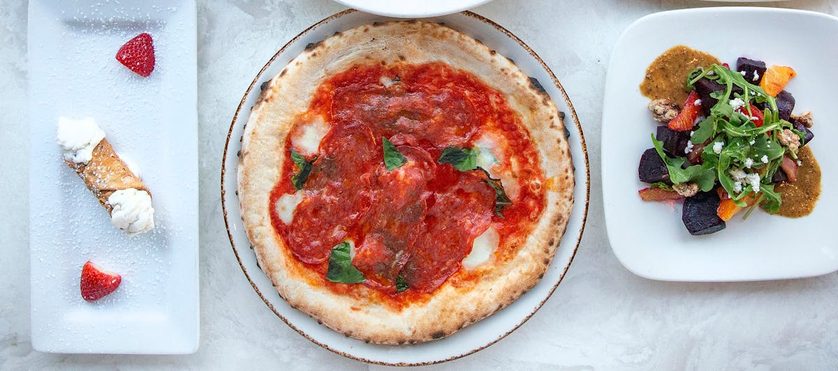 a plate of food with a slice of pizza