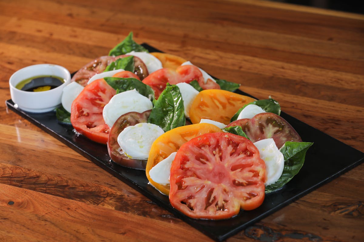 tomato slices with mozzarella and spinach
