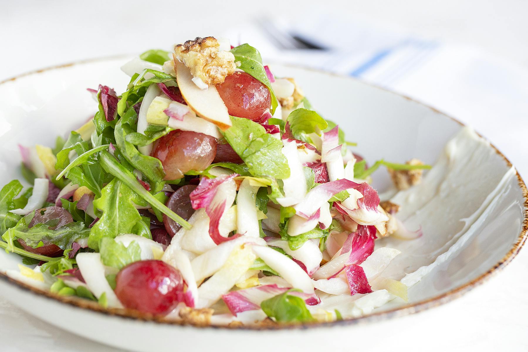 a white plate topped with a salad