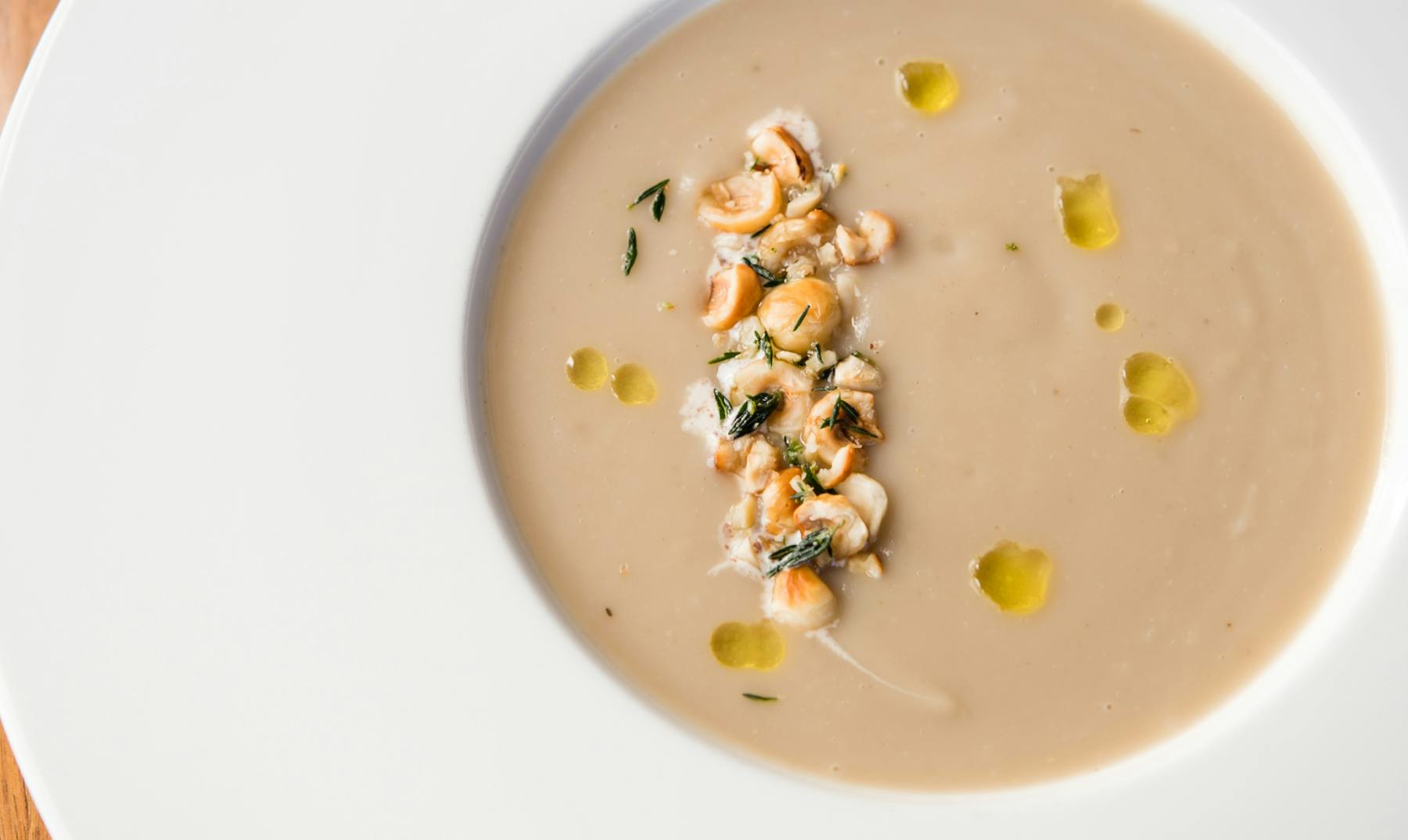 a bowl of soup on a white plate