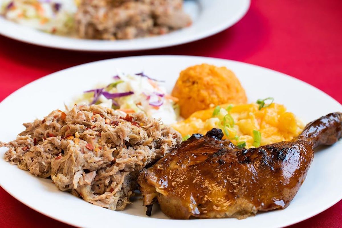 a white plate topped with meat and vegetables