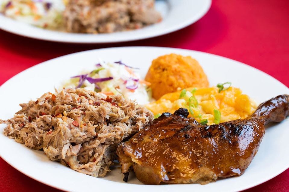 a white plate topped with meat and vegetables